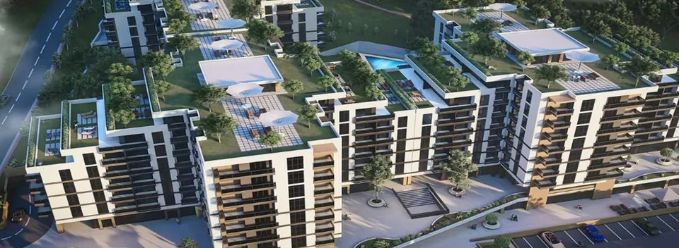 Vizualizare aeriană a ansamblului rezidențial Rosetti din Iași: blocuri de locuințe albe cu balcoane, terase verzi amenajate pe acoperiș și piscină, parcare în prim-plan